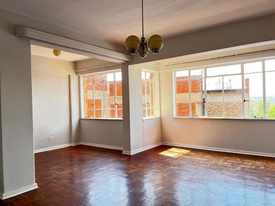 Sunny lounge with parquet floors in a Joburg flat
