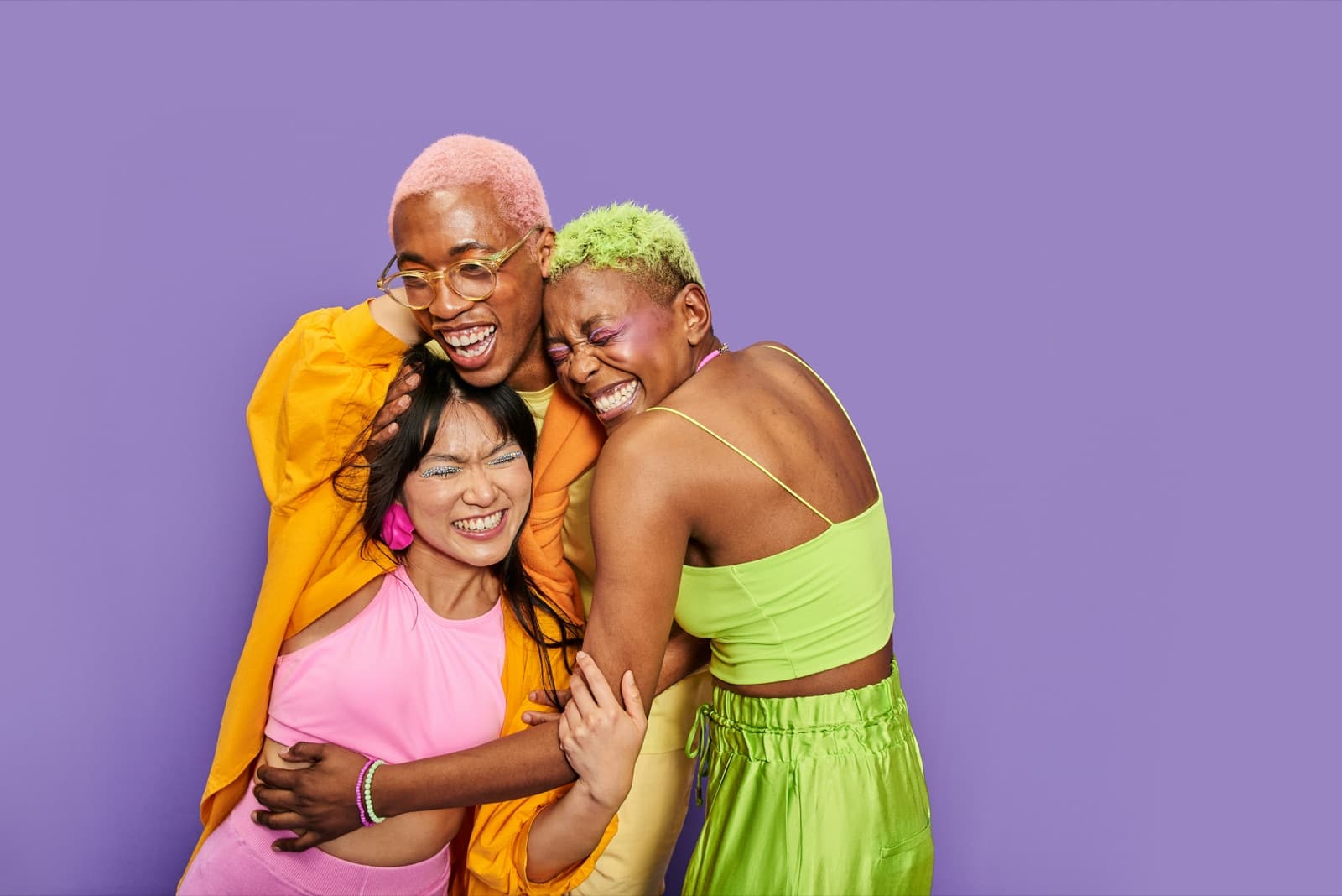 Three friends hugging and laughing